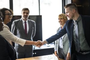 A high-performance business environment with business leaders shaking hands.